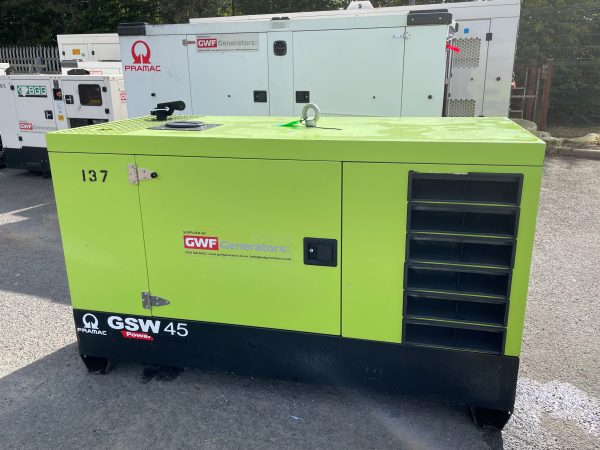 a green pramac generator in a yard full of other generators